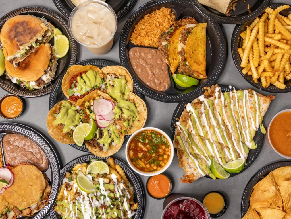 An overhead spread of Pio Pico's tacos, quesabirria, quesadillas, burritos and aguas frescas
