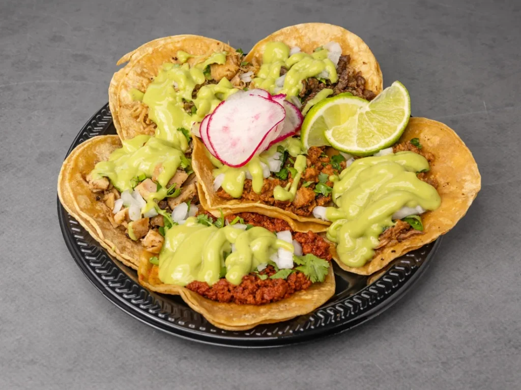 Street tacos with guacamole, cilantro, radish, and lime